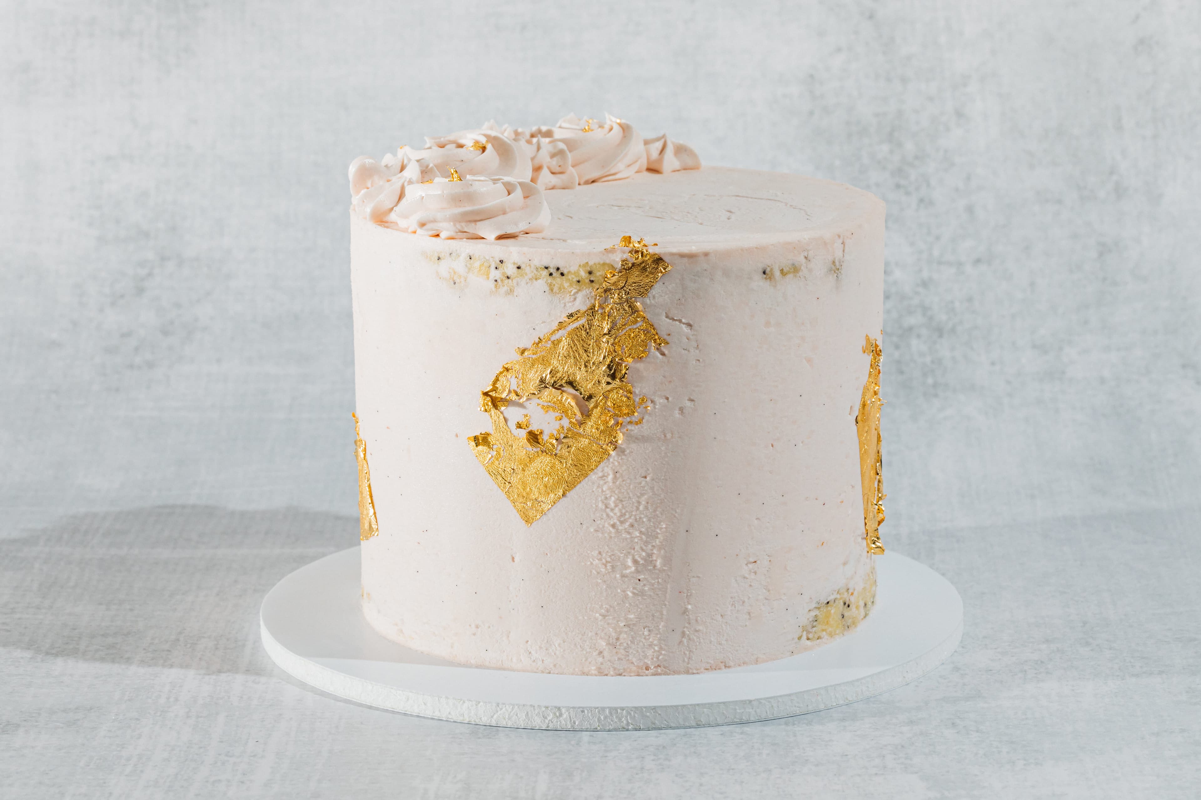 pink cake with gold leaf