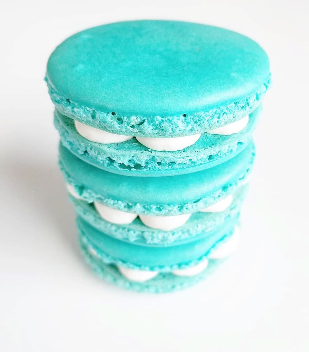 teal macarons stacked